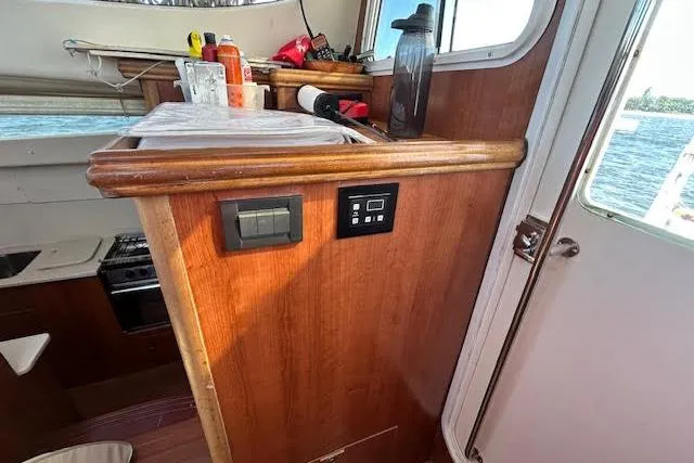 Slide: The Image of Interior of 2013 Gemini Legacy yacht featuring kitchen and seating area with modern amenities. - 6