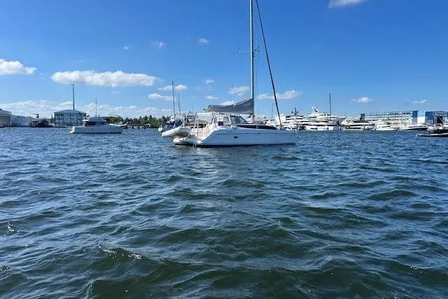 Slide: The Image of Cozy cabin interior of 2013 Gemini Legacy boat with wooden finish and blue bedding. - 9