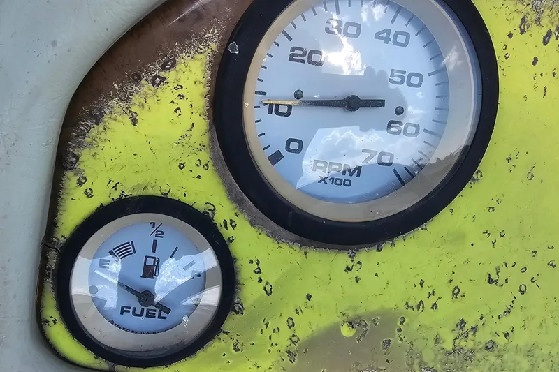 Slide: The Image of Close-up of ProCraft 180 Combo 2004 boat gauges, showing RPM and fuel levels. - 10