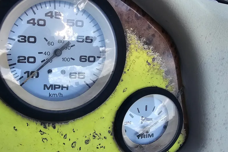 Slide: The Image of Dashboard of a 2004 ProCraft 180 Combo boat with speedometer and trim gauge. - 11