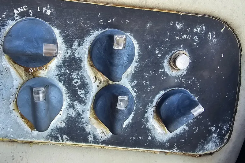 Slide: The Image of Control panel of a 2004 ProCraft 180 Combo boat with switches and labels. - 12