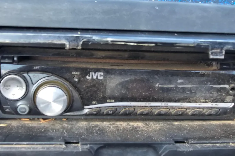 Slide: The Image of JVC car stereo in a 2004 ProCraft 180 Combo, showing buttons and volume knob. - 16