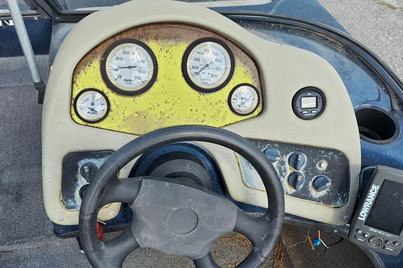 Slide: The Image of Dashboard of a 2004 ProCraft 180 Combo boat with gauges and steering wheel. - 9