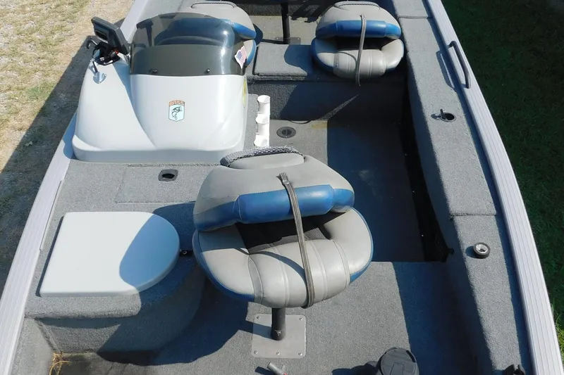 Slide: The Image of 2009 Eagle G3 175 PF boat interior with gray and blue seating, steering console, and carpeted floor. - 4