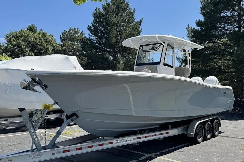 The Image of 2026 Sea Hunt Gamefish 30 Forward Seating boat on a trailer, parked outdoors. - 1