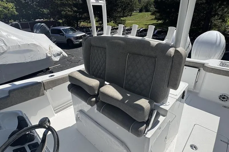 Slide: The Image of 2026 Sea Hunt Gamefish 30 Forward Seating with cushioned helm seats and rod holders. - 10