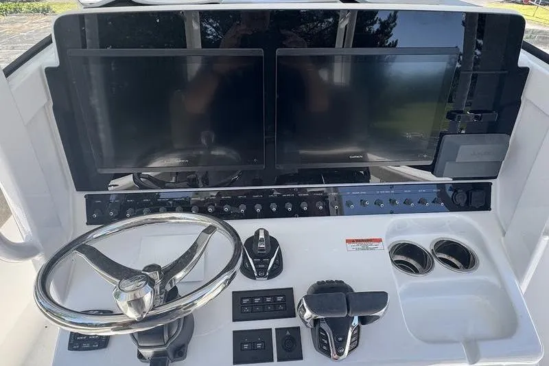 Slide: The Image of 2026 Sea Hunt Gamefish 30 helm with dual screens and modern controls. - 14