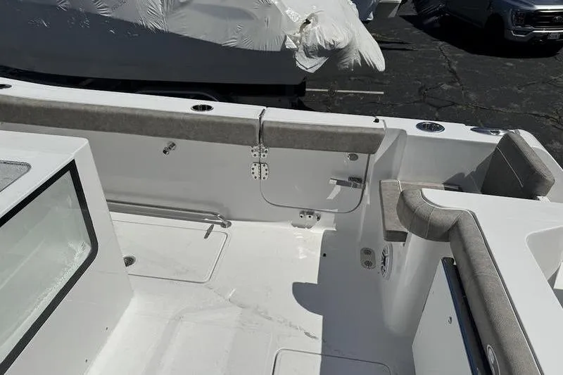 Slide: The Image of 2026 Sea Hunt Gamefish 30 Forward Seating boat interior with cushioned seating and storage. - 17