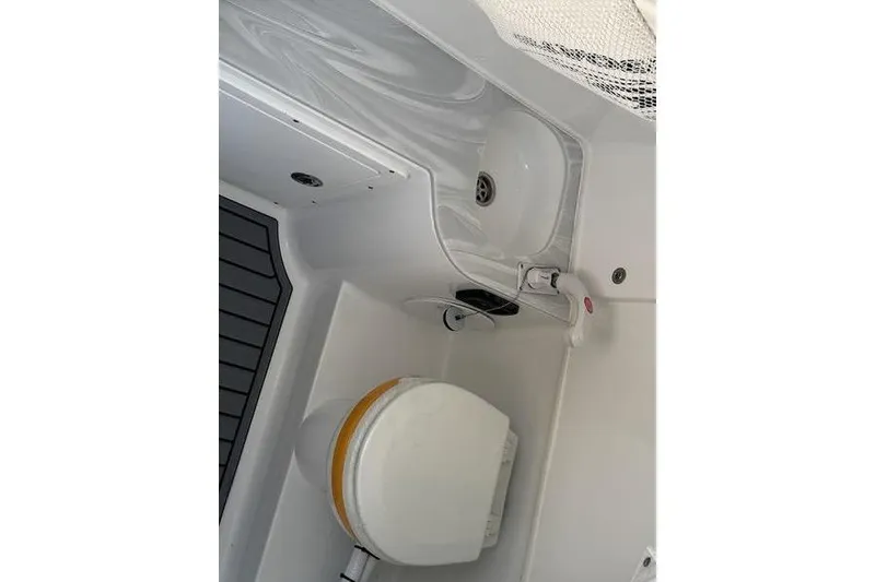Slide: The Image of Interior of 2026 Sea Hunt Gamefish 30, featuring a compact marine toilet and sink. - 6