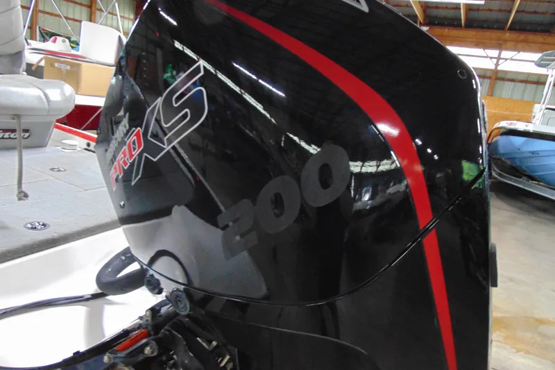 Slide: The Image of 2005 Triton Tr-196 PD boat with Mercury Pro XS 200 engine in a garage. - 4