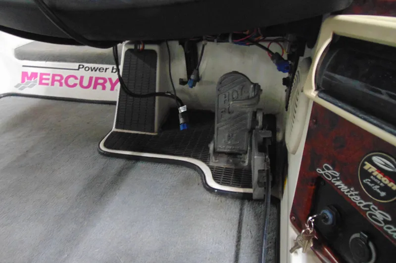 Slide: The Image of 2005 Triton Tr-196 PD boat interior with Mercury controls and foot pedal. - 7