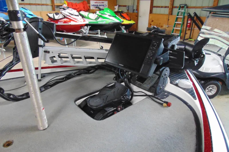 Slide: The Image of 2005 Triton Tr-196 PD boat with advanced navigation equipment in a storage facility. - 9