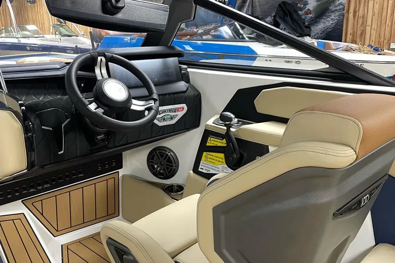 Slide: The Image of Interior of 2025 Nautique Super Air Nautique S23 boat, featuring modern steering and controls. - 7