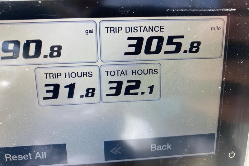 Slide: The Image of Display screen showing trip data: 90.8 gallons, 305.8 miles, 31.8 trip hours. Key West 203 DFS. - 11