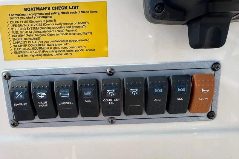 Slide: The Image of Control panel of a 2023 Key West 203 DFS boat with labeled switches and checklist. - 13