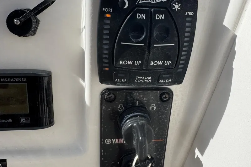 Slide: The Image of Control panel of 2023 Key West 203 DFS boat with Yamaha ignition and trim tab controls. - 14