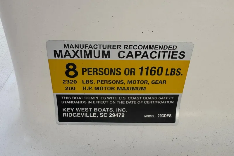 Slide: The Image of 2023 Key West 203 DFS capacity label: 8 persons or 1160 lbs, 200 HP motor max. - 15