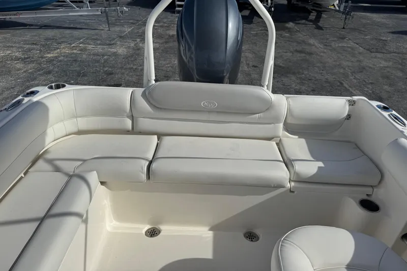 Slide: The Image of 2023 Key West 203 DFS boat interior with white seating and cup holders. - 19