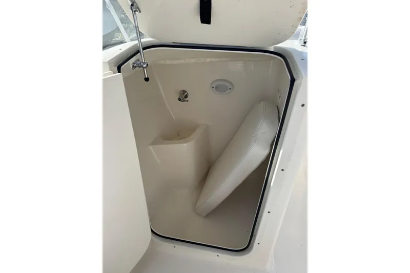 Slide: The Image of 2023 Key West 203 DFS boat storage compartment with cushion and faucet. - 20