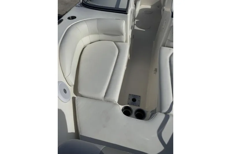 Slide: The Image of 2023 Key West 203 DFS boat interior with white cushioned seating and cup holders. - 22