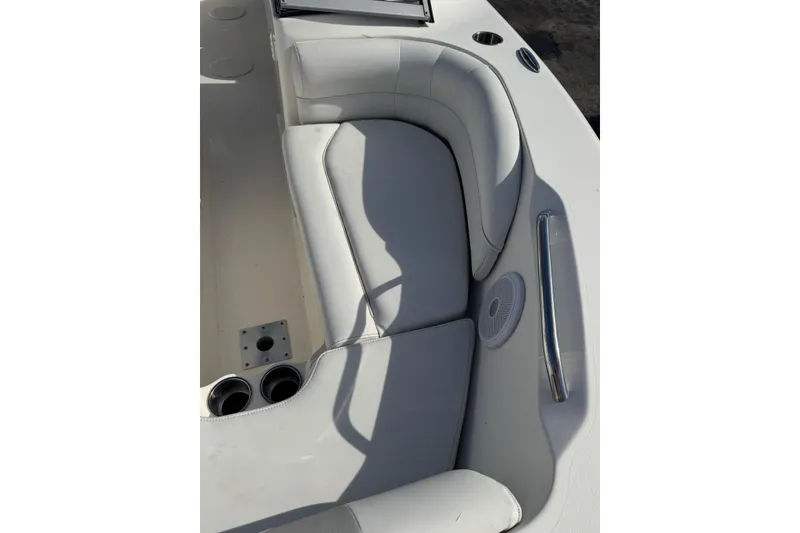 Slide: The Image of 2023 Key West 203 DFS boat interior with cushioned seating and cup holders. - 23