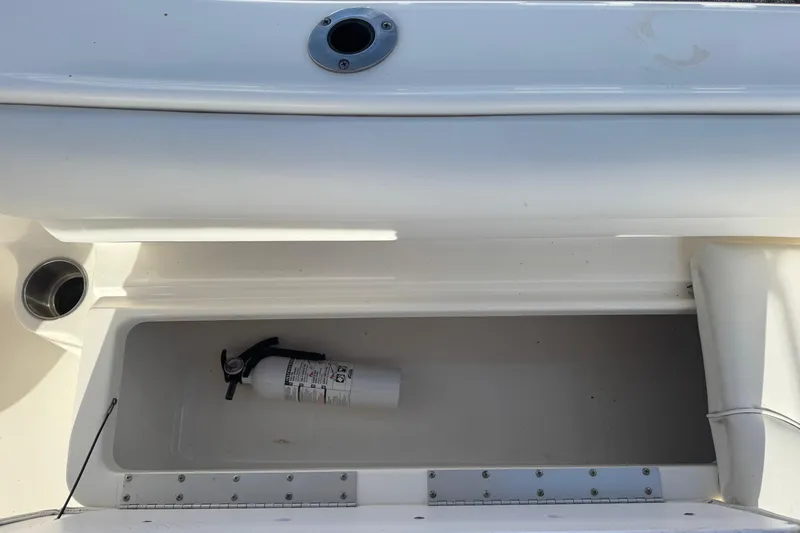 Slide: The Image of Storage compartment with fire extinguisher on 2023 Key West 203 DFS boat. - 27