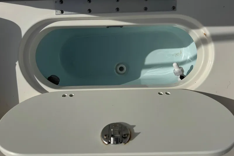 Slide: The Image of 2023 Key West 203 DFS boat livewell with open lid, showcasing interior details. - 28