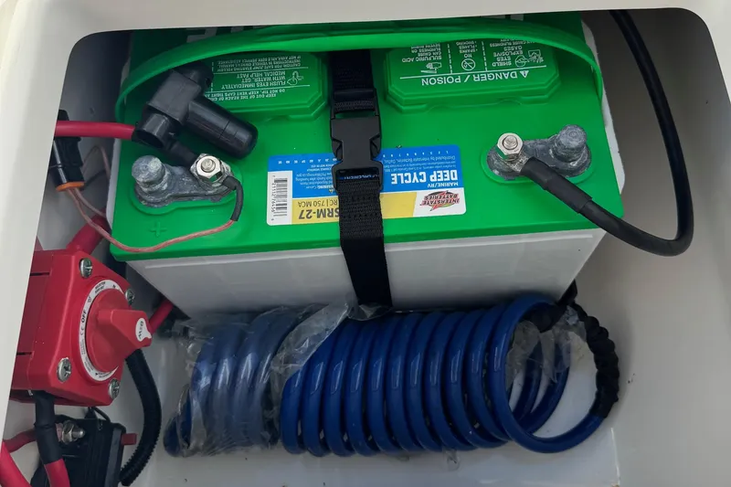 Slide: The Image of Battery compartment of 2023 Key West 203 DFS boat with deep cycle battery and wiring. - 29