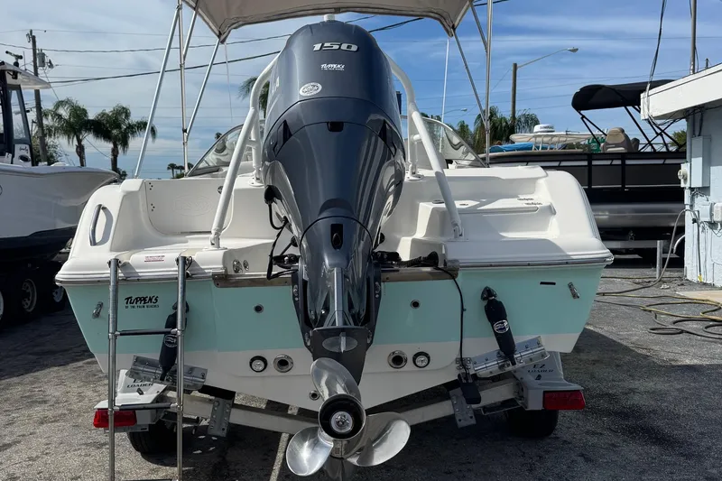 Slide: The Image of 2023 Key West 203 DFS boat with powerful outboard motor, parked on a trailer. - 3