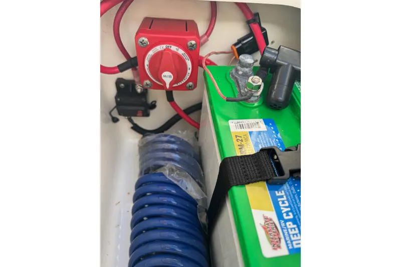 Slide: The Image of 2023 Key West 203 DFS boat battery compartment with deep cycle battery and power switch. - 30