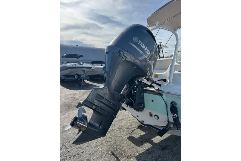 Slide: The Image of 2023 Key West 203 DFS boat with Yamaha outboard motor in a marina setting. - 34