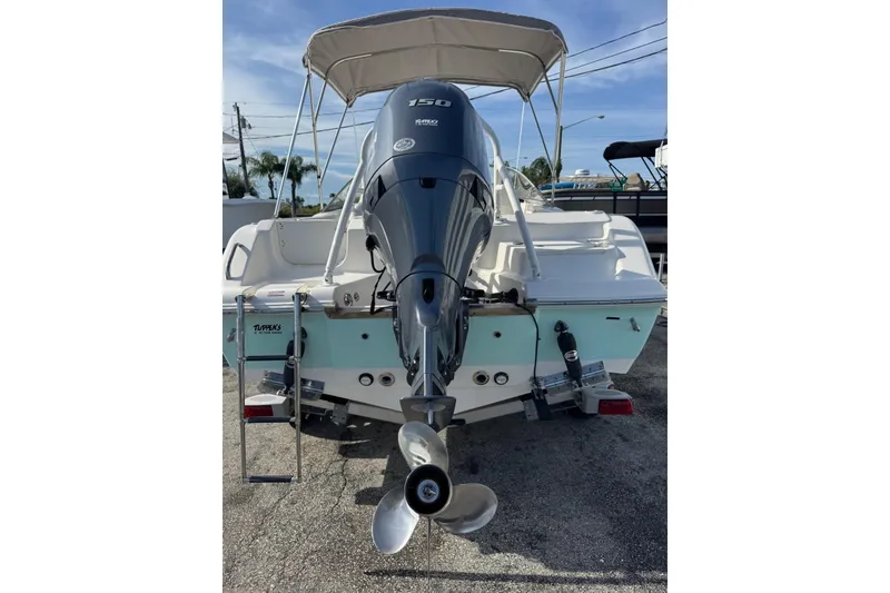 Slide: The Image of 2023 Key West 203 DFS boat with outboard motor and canopy, rear view. - 35