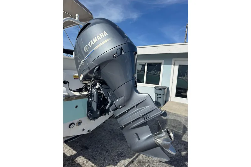 Slide: The Image of 2023 Key West 203 DFS boat with Yamaha outboard motor, parked outdoors. - 36