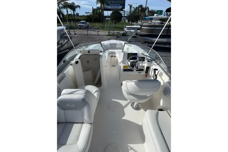 Slide: The Image of 2023 Key West 203 DFS boat interior with white seating and steering console. - 4