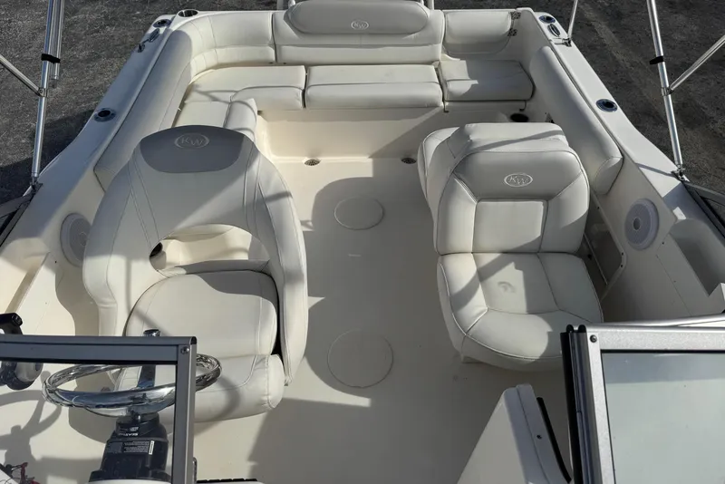 Slide: The Image of 2023 Key West 203 DFS boat interior with white seating and steering wheel. - 7