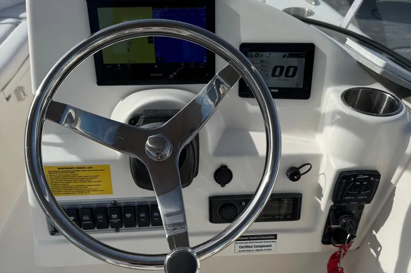 Slide: The Image of Steering console of 2023 Key West 203 DFS boat with navigation controls and displays. - 8