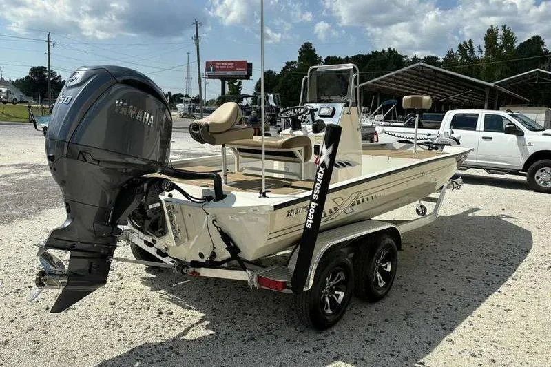 Slide: The Image of 2026 Xpress H210B boat with Yamaha engine on trailer, parked outdoors. - 3