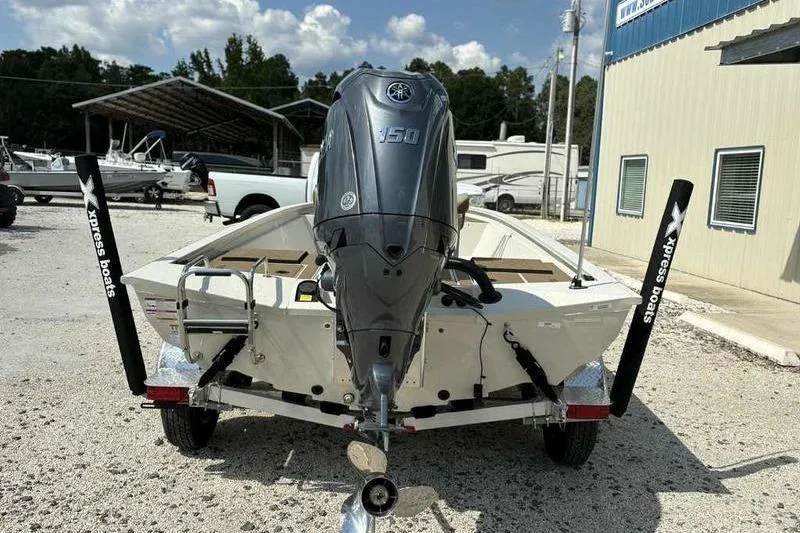 Slide: The Image of 2026 Xpress H210B boat with Yamaha 150 engine, parked outdoors. - 4
