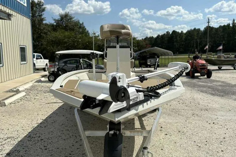Slide: The Image of 2026 Xpress H210B boat with Minn Kota trolling motor, parked outdoors on gravel. - 5