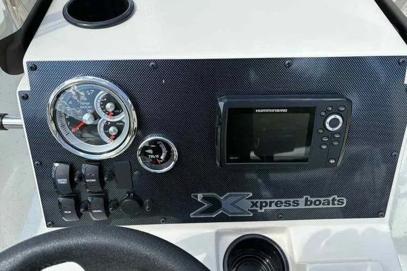 Slide: The Image of Dashboard of 2026 Xpress H210B boat with gauges and Humminbird display. - 7