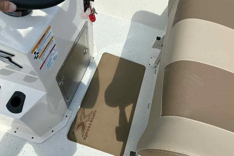 Slide: The Image of Interior of 2026 Xpress H210B boat showing steering console and seating area. - 8