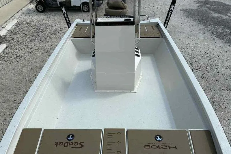 Slide: The Image of 2026 Xpress H210B boat interior with center console and SeaDek flooring. - 9