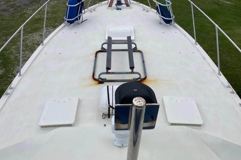 Slide: The Image of 1985 Hatteras Sportfish boat deck with railings and equipment, viewed from above. - 15