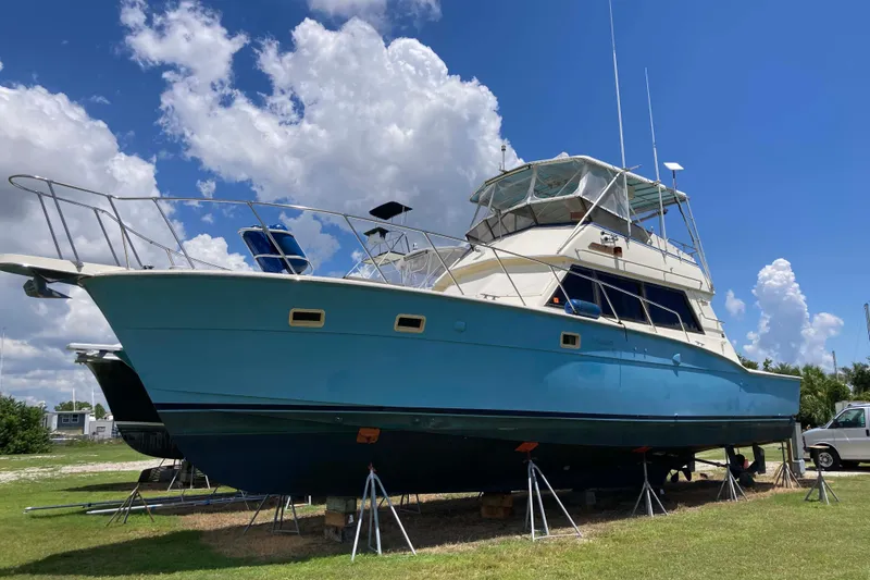 Slide: The Image of 1985 Hatteras Sportfish boat on stands under a bright blue sky. - 2
