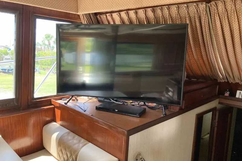 Slide: The Image of Interior of 1985 Hatteras Sportfish with TV and wood paneling. - 26