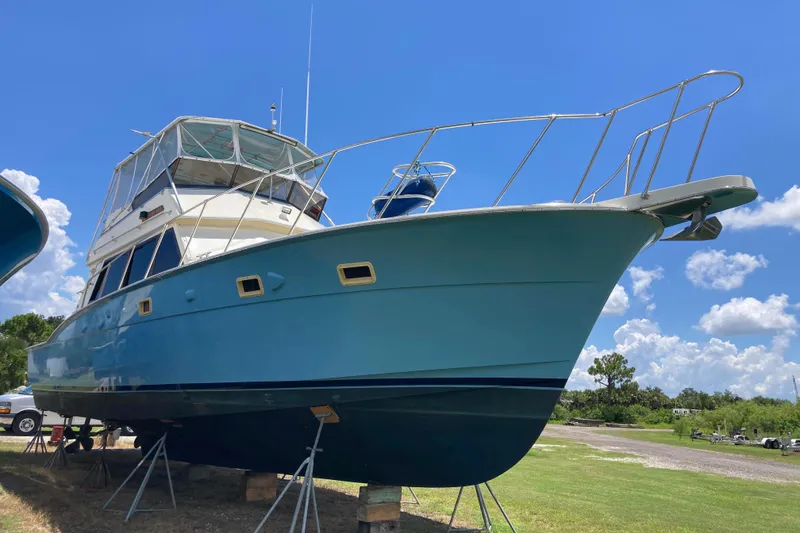 Slide: The Image of 1985 Hatteras Sportfish boat on stands under a clear blue sky. - 3