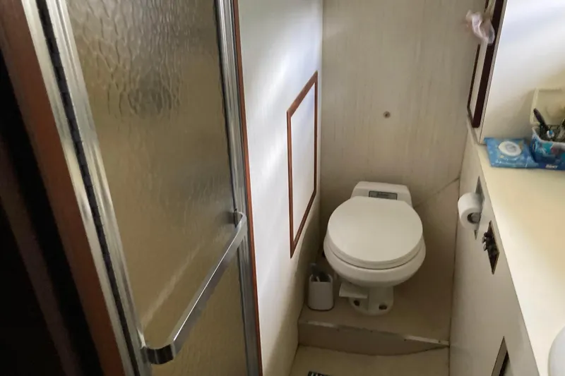Slide: The Image of Bathroom interior of a 1985 Hatteras Sportfish yacht with shower and toilet. - 34