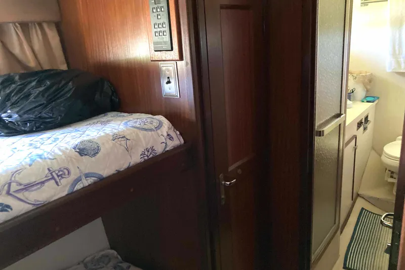 Slide: The Image of 1985 Hatteras Sportfish cabin interior with bunk bed and bathroom. - 37