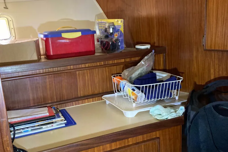 Slide: The Image of Interior of 1985 Hatteras Sportfish with storage shelves and various items. - 42