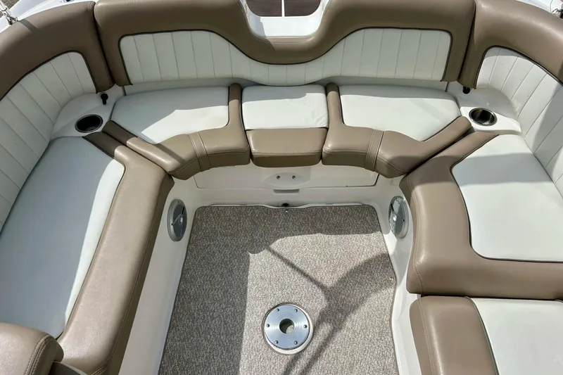 Slide: The Image of 2008 Searay SX 232 boat interior with beige and white cushioned seating. - 10